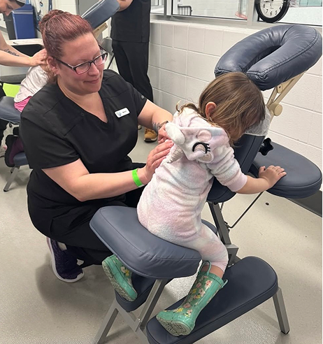 Massage therapist working with a young client